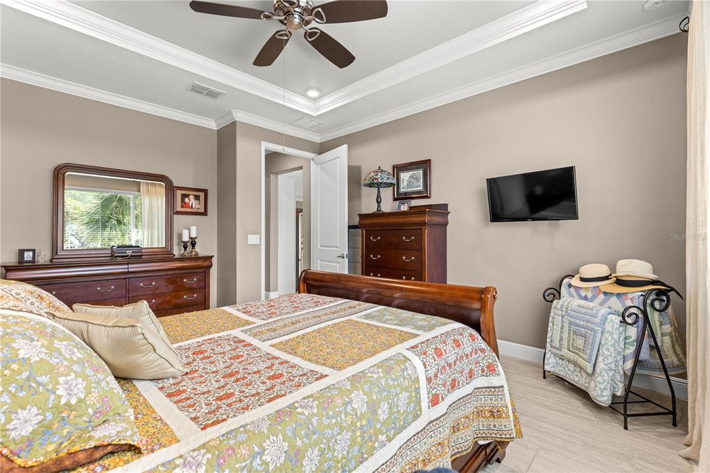 9099 Southwest 89th Loop Ocala, FL 34481 - Photo 35 of 66 a bedroom with a bed and a flat screen tv