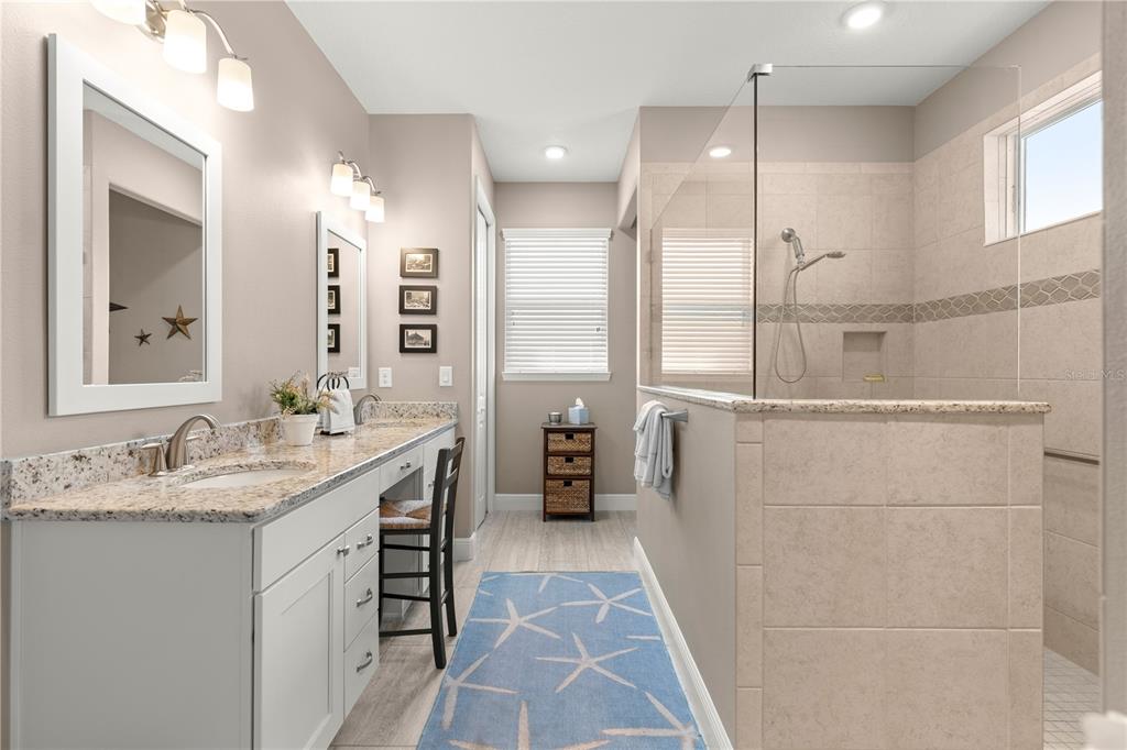 9099 Southwest 89th Loop Ocala, FL 34481 - Photo 39 of 66 a bathroom with a double vanity sink and a mirror