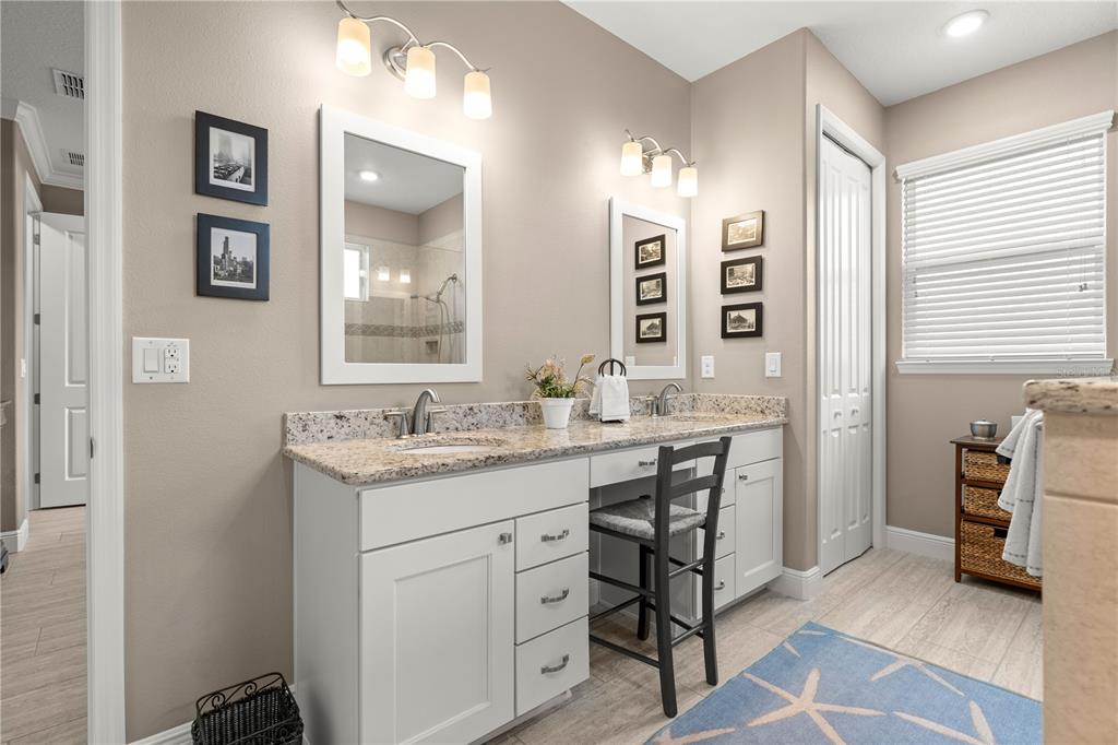 9099 Southwest 89th Loop Ocala, FL 34481 - Photo 40 of 66 a bathroom with a granite countertop sink a toilet and a mirror