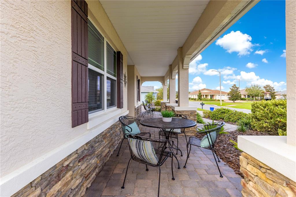 9099 Southwest 89th Loop Ocala, FL 34481 - Photo 5 of 66 a view of a patio with table and chairs and potted plants