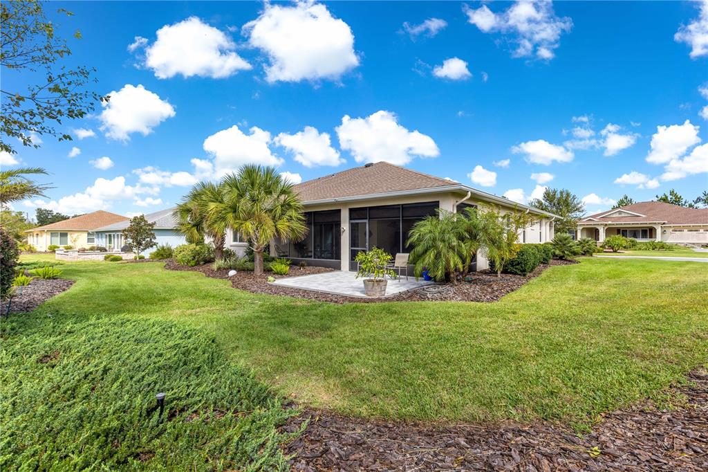 9099 Southwest 89th Loop Ocala, FL 34481 - Photo 53 of 66 a view of a house with backyard porch and sitting area