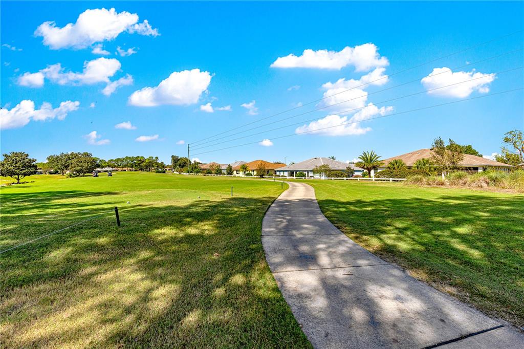 9099 Southwest 89th Loop Ocala, FL 34481 - Photo 64 of 66 a view of a golf course with a lake