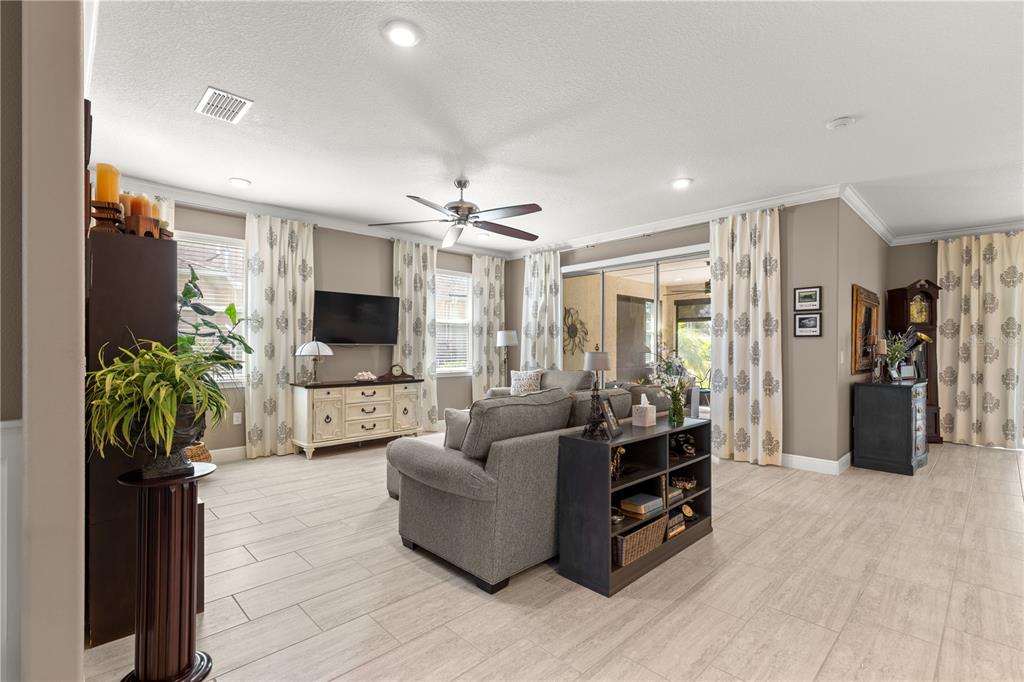 9099 Southwest 89th Loop Ocala, FL 34481 - Photo 9 of 66 a living room with furniture and a flat screen tv