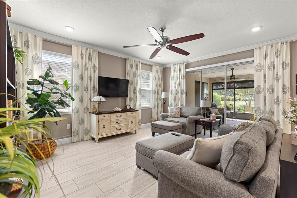 9099 Southwest 89th Loop Ocala, FL 34481 - Photo 10 of 66 a living room with furniture a flat screen tv and a large window