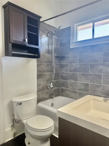 a bathroom with a sink a toilet and bathtub