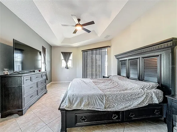 a bedroom with a bed and a chandelier