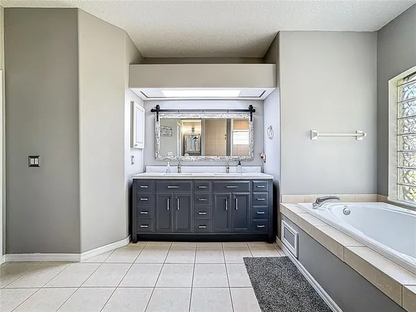 a bedroom with a bed and a ceiling fan