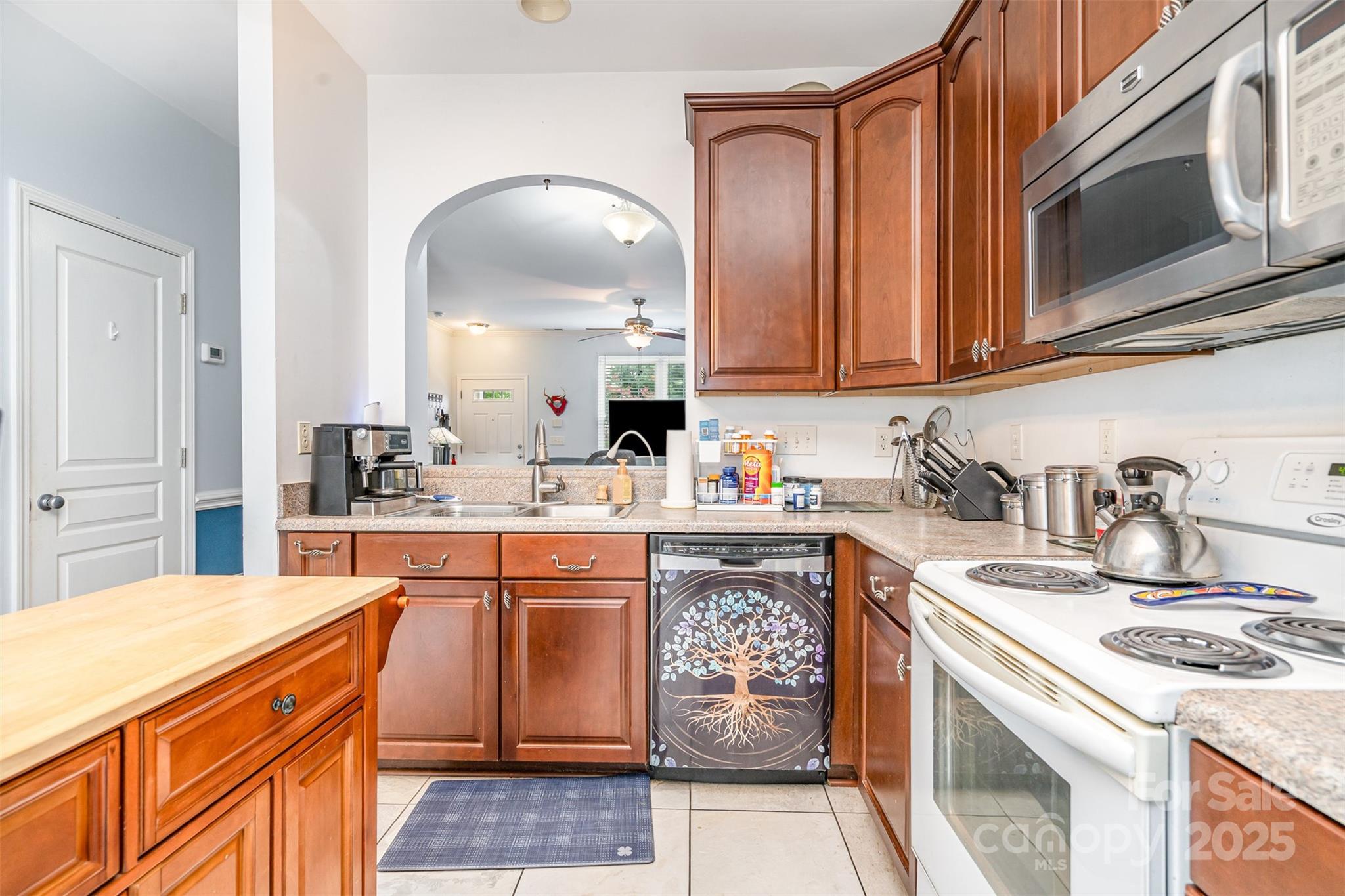 208 Dawn Mist Lane Fort Mill, SC 29708 - Photo 11 of 30 a kitchen with stainless steel appliances granite countertop a sink stove and cabinets
