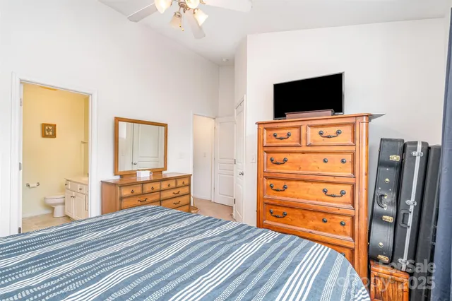 a bedroom with furniture and flat screen tv