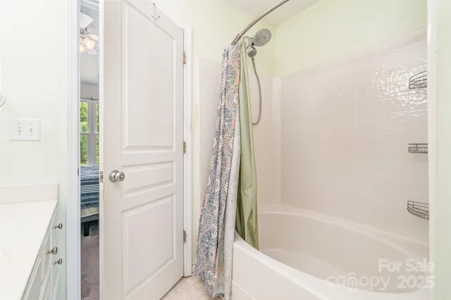 a bathroom with a bathtub and shower