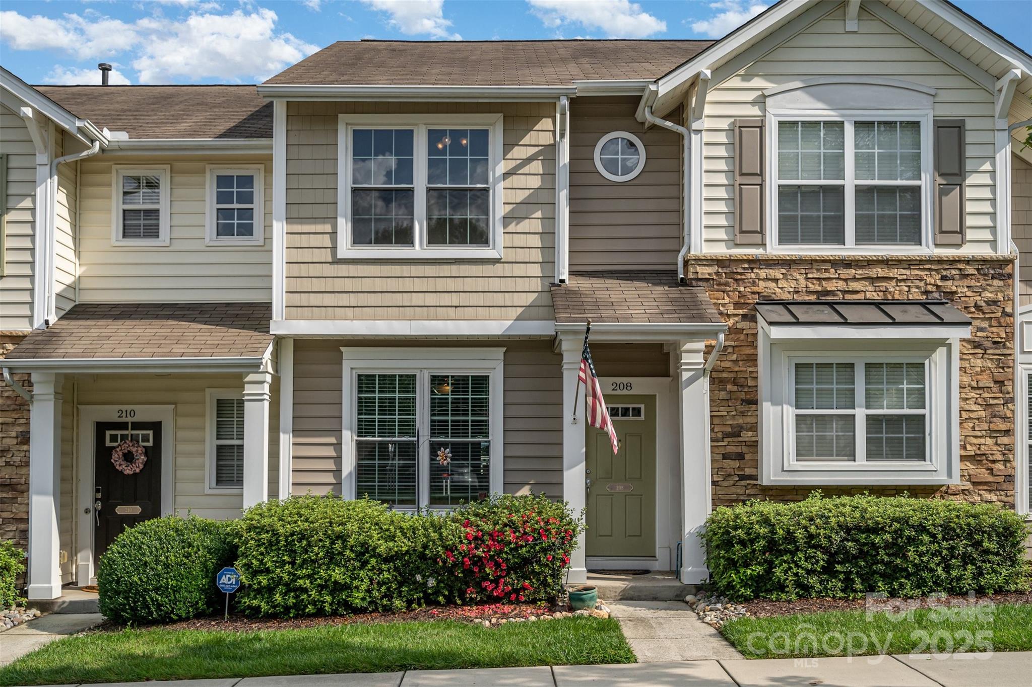 208 Dawn Mist Lane Fort Mill, SC 29708 - Photo 3 of 30 a view of a brick house with a large windows and plants