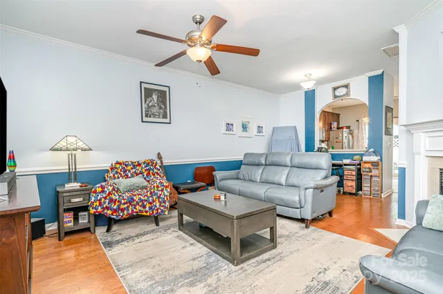 a living room with furniture and a lamp