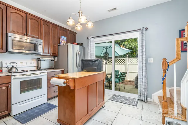 a kitchen with stainless steel appliances granite countertop a stove and a refrigerator