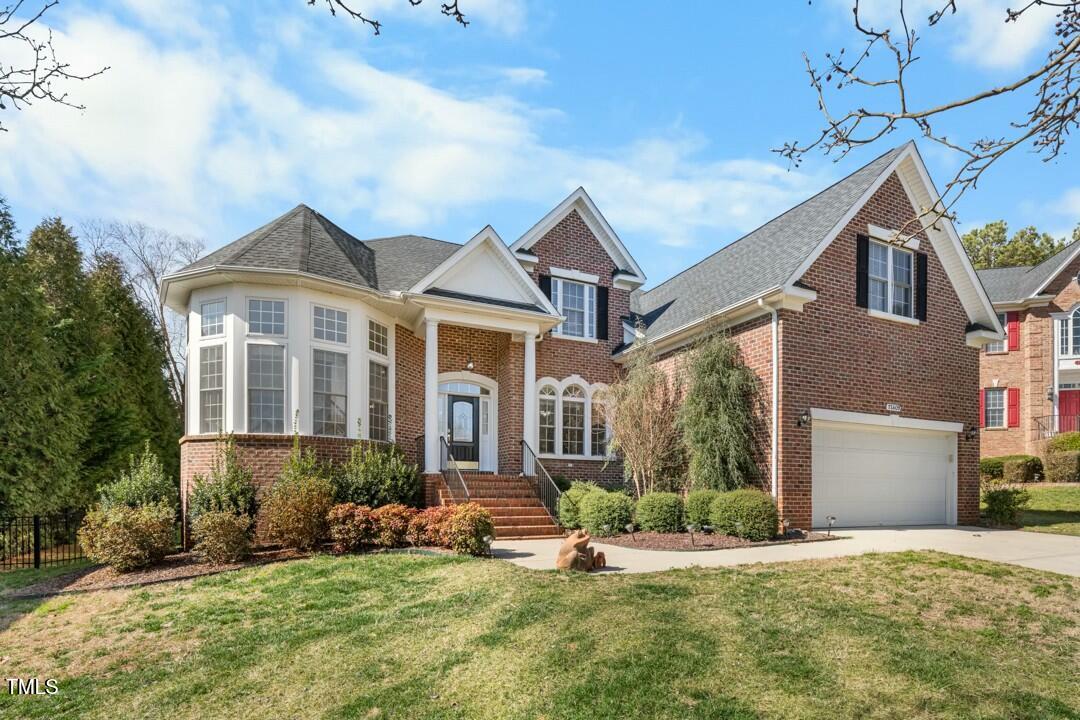 12409 Village Gate Way Raleigh, NC 27614 - Photo 1 of 42 a front view of a house with a yard and garage