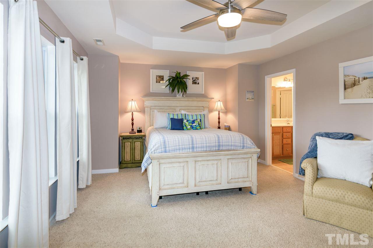 8630 Redcrest Place Raleigh, NC 27617 - Photo 13 of 24 a living room with a bed furniture and a window