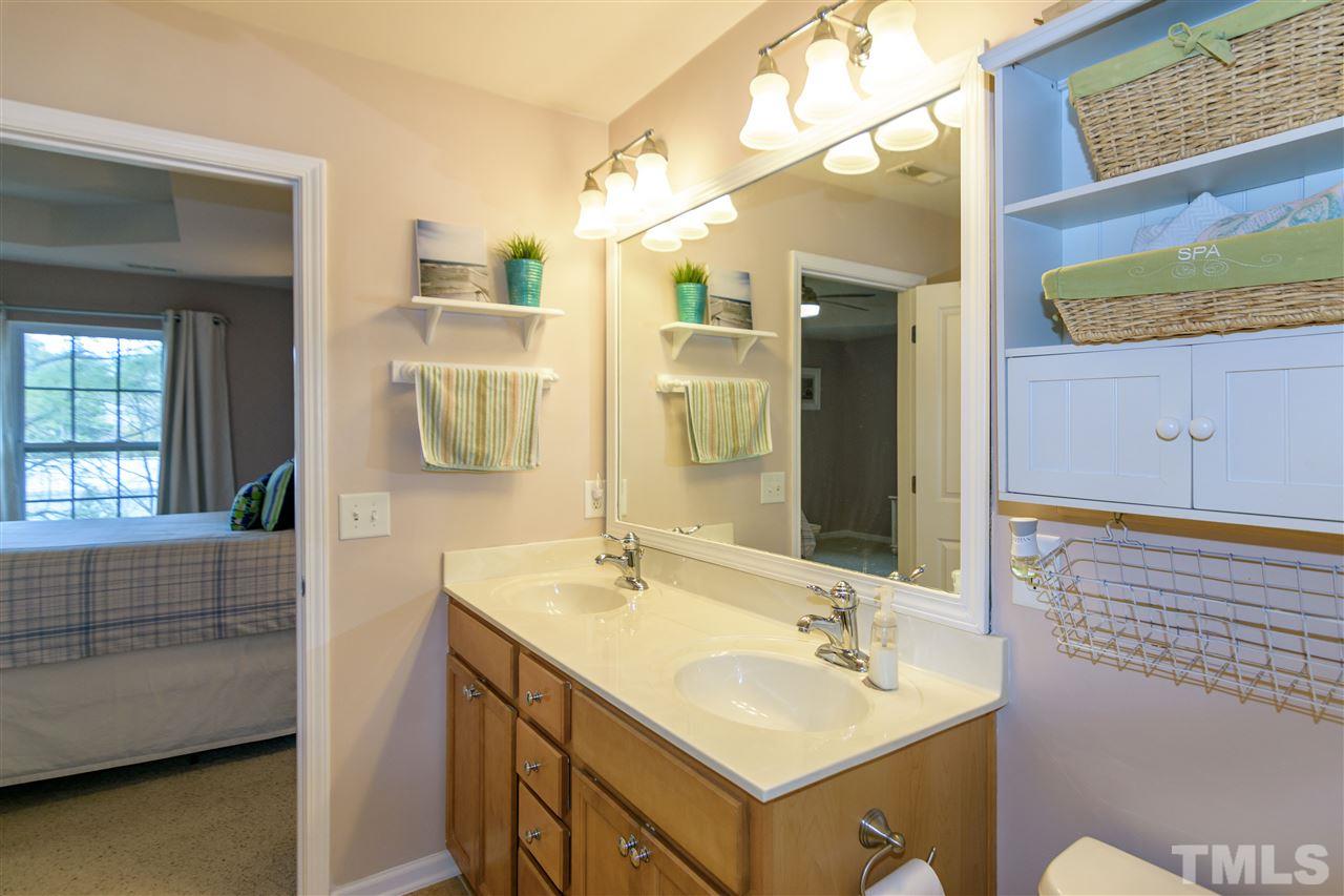 8630 Redcrest Place Raleigh, NC 27617 - Photo 14 of 24 a bathroom with a sink and a mirror