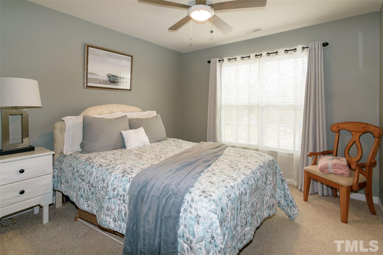 8630 Redcrest Place Raleigh, NC 27617 - Photo 16 of 24 a bedroom with a bed and a window