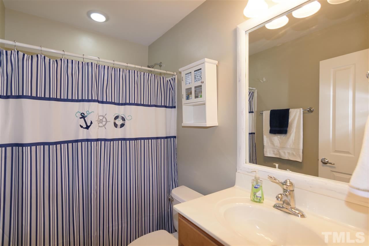 8630 Redcrest Place Raleigh, NC 27617 - Photo 17 of 24 a bathroom with a sink and a mirror