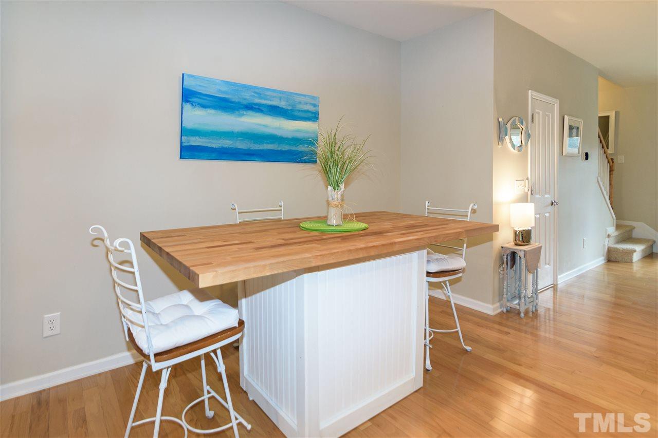 8630 Redcrest Place Raleigh, NC 27617 - Photo 3 of 24 a dining room with table chairs and a potted plant