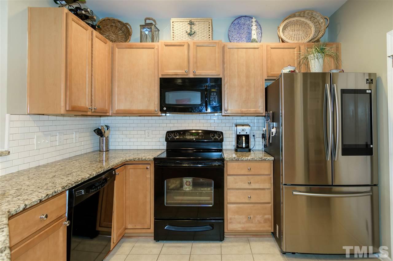 8630 Redcrest Place Raleigh, NC 27617 - Photo 5 of 24 a kitchen with stainless steel appliances granite countertop a refrigerator stove and sink