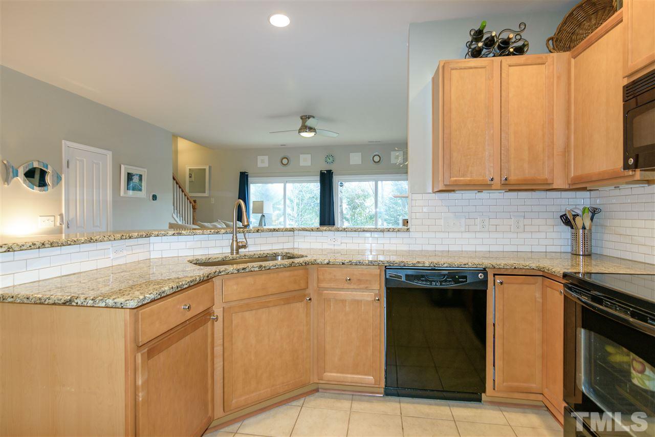 8630 Redcrest Place Raleigh, NC 27617 - Photo 6 of 24 a kitchen with granite countertop a sink and cabinets