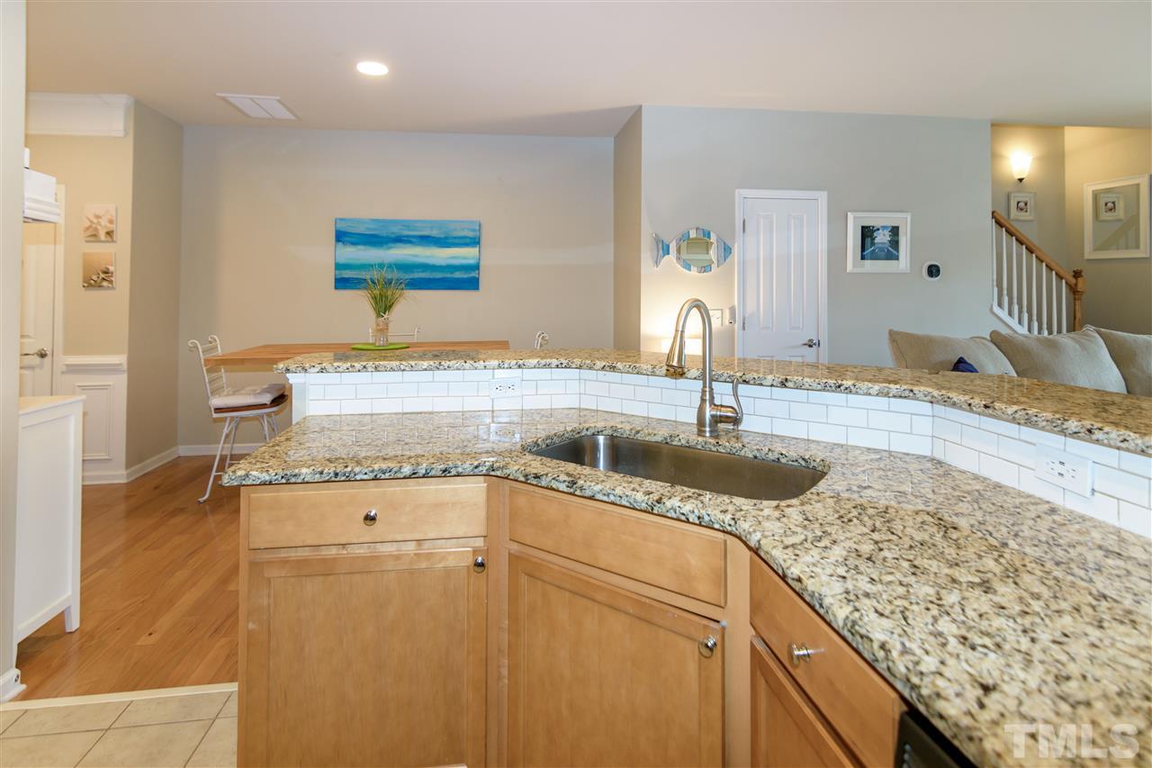 8630 Redcrest Place Raleigh, NC 27617 - Photo 7 of 24 a kitchen with granite countertop a sink and a stove