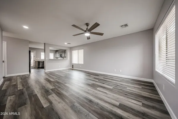 wooden floor in an empty room with a window