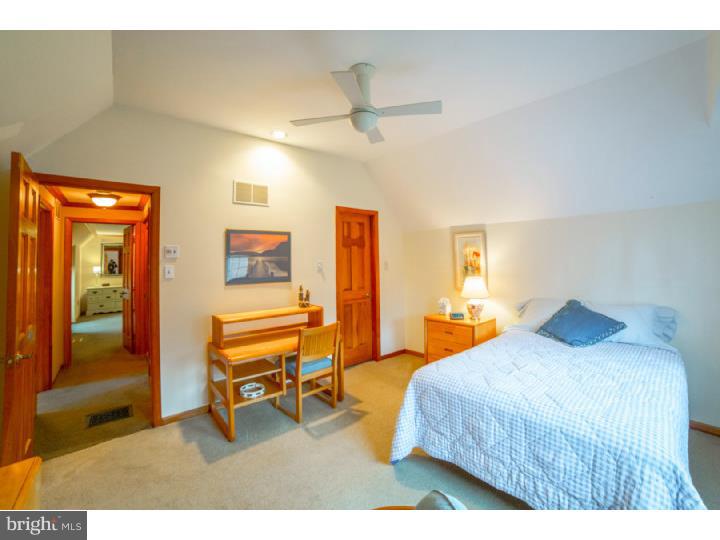 11 Foxchase Road Tabernacle, NJ 08088 - Photo 18 of 25 a bedroom with a bed and a chandelier