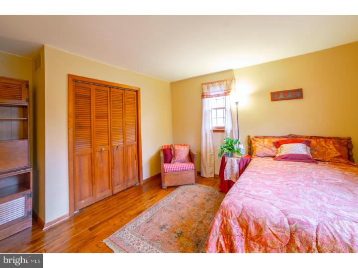 11 Foxchase Road Tabernacle, NJ 08088 - Photo 21 of 25 a bedroom with a large bed and wooden floor