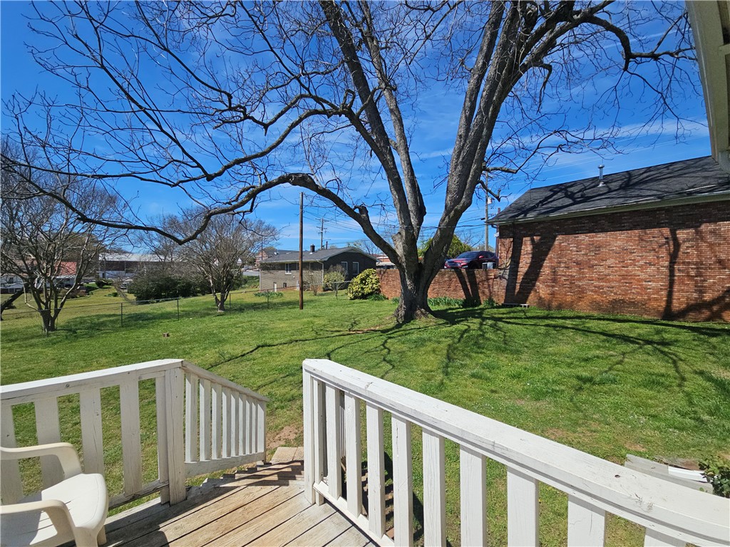 208 Pendleton Street Pickens, SC 29671 - Photo 3 of 30 This spacious backyard features a charming deck, perfect for outdoor enjoyment.