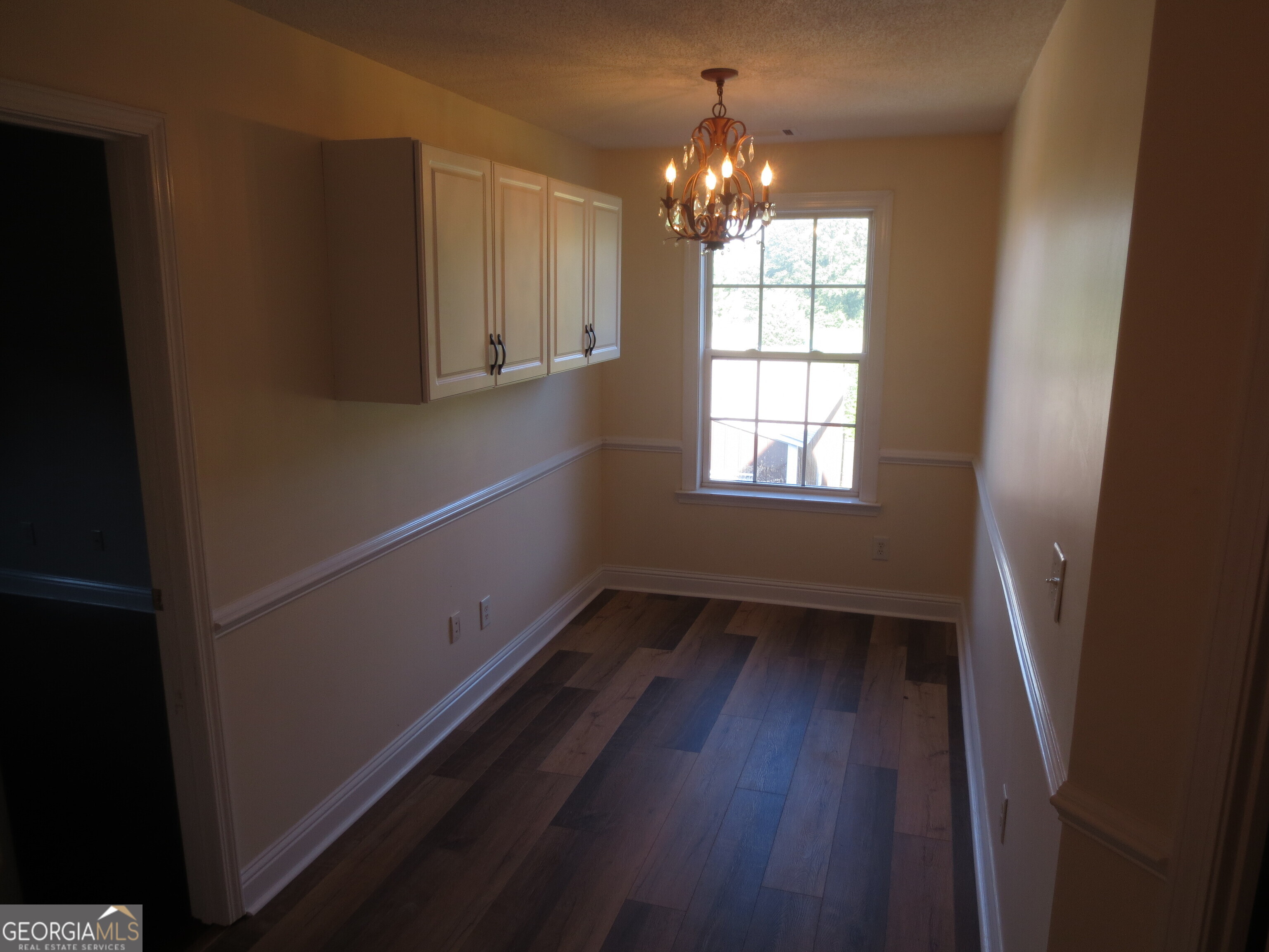 184 Giles Road Warner Robins, GA 31093 - Photo 17 of 31 a view of empty room with wooden floor and fan