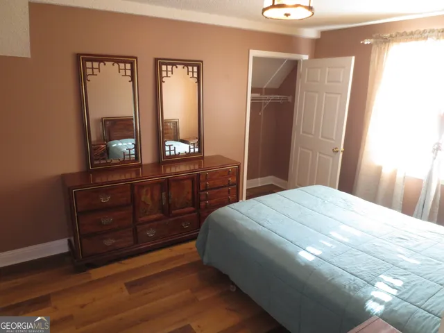 a bedroom with a bed and a dresser
