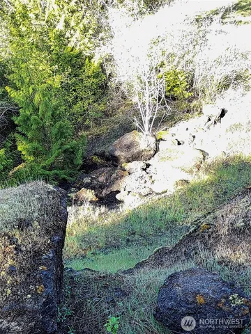 a view of house with backyard and outdoor seating