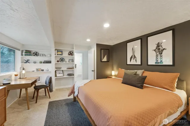 a bedroom with a bed and a bookshelf