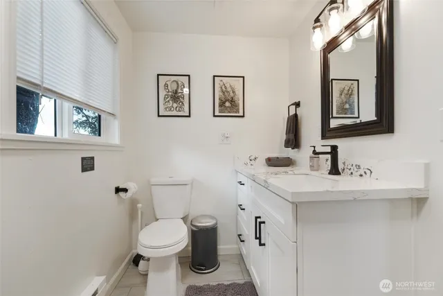 a bathroom with a toilet sink and mirror