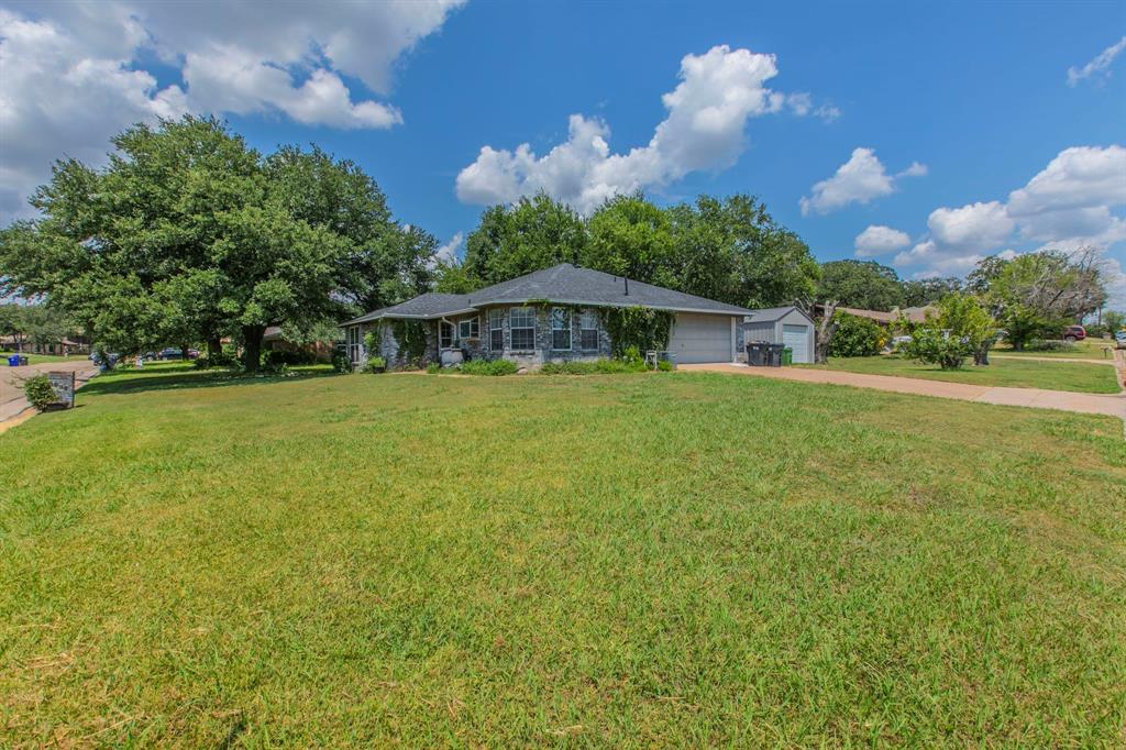 1936 Post Oak Drive Waco, TX 76705 - Photo 28 of 33 View of front facade with a front lawn, concrete driveway, and an attached garage