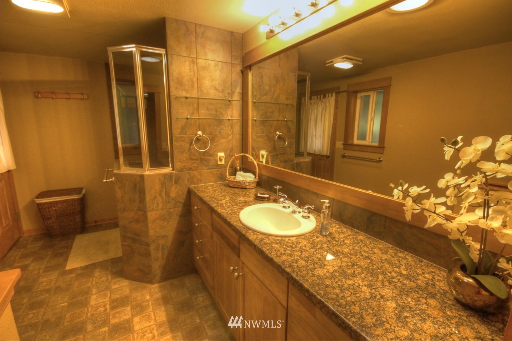 509 Bayside Road Bellingham, WA 98225 - Photo 12 of 17 a bathroom with a granite countertop sink and a mirror