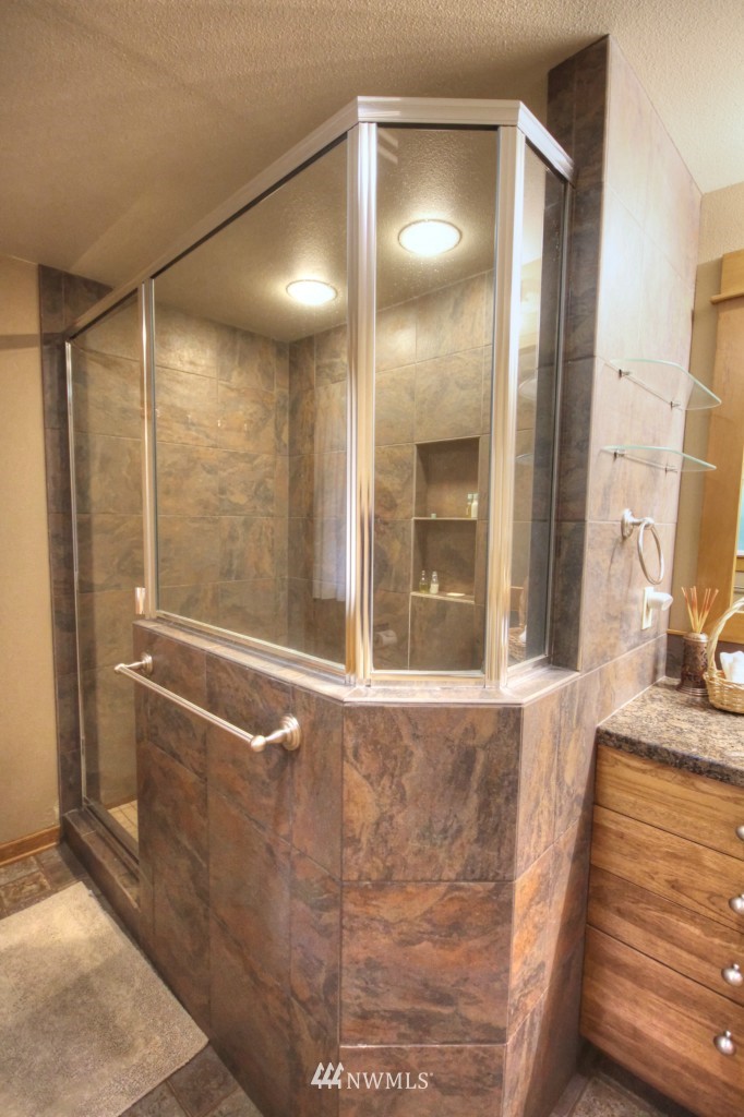 509 Bayside Road Bellingham, WA 98225 - Photo 13 of 17 a bathroom with a glass shower door