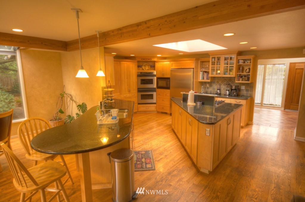 509 Bayside Road Bellingham, WA 98225 - Photo 4 of 17 a kitchen with stainless steel appliances granite countertop a sink and a refrigerator