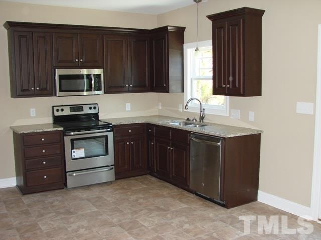 2214 Flowing Drive Raleigh, NC 27610 - Photo 3 of 14 a kitchen with a sink and a stove