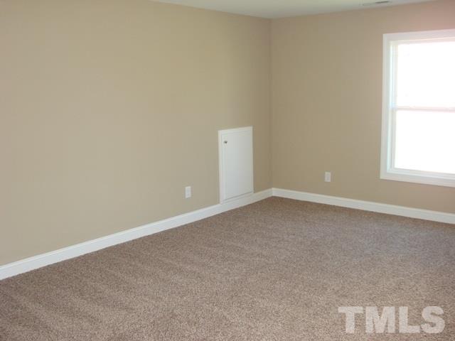 2214 Flowing Drive Raleigh, NC 27610 - Photo 6 of 14 an empty room with a window