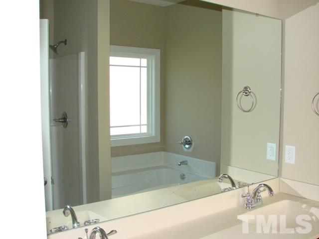 2214 Flowing Drive Raleigh, NC 27610 - Photo 7 of 14 a bathroom with a tub and a sink