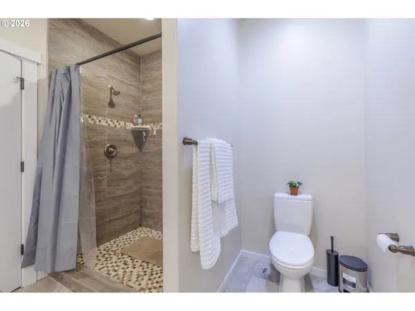 a bathroom with a toilet and a shower