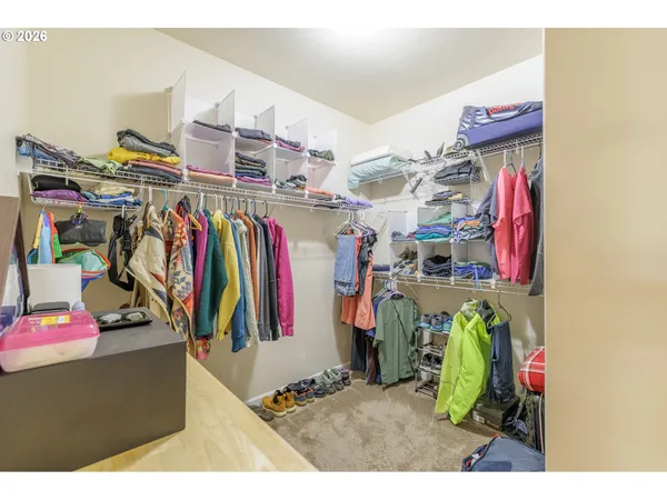 a view of walk in closet with clothes
