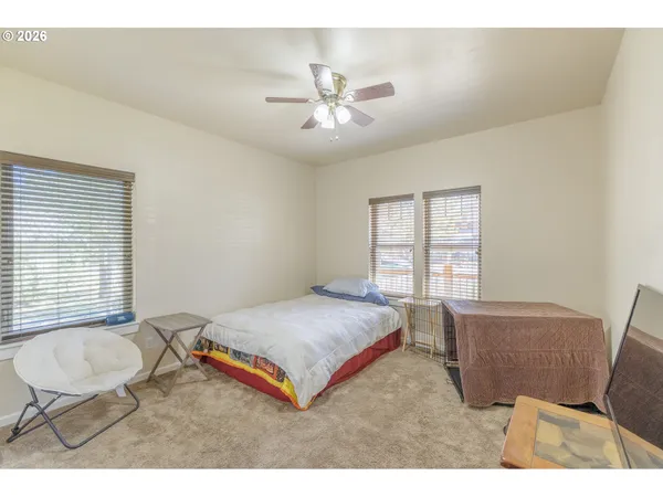 a bedroom with a bed and a chair