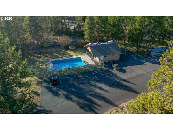 a view of an aerial view of residential houses with outdoor space and trees