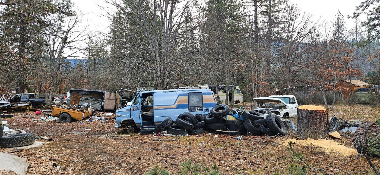 1240 Morgan Hill Road Hayfork, CA 96041 - Photo 17 of 25 a view of a patio with table and chairs a barbeque with wooden fence