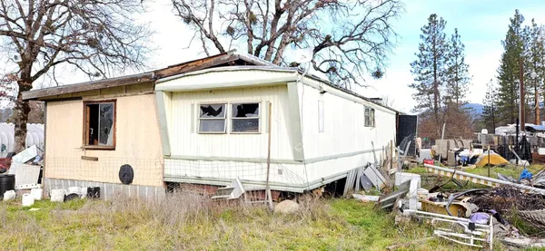 a backyard of a house with table and chairs