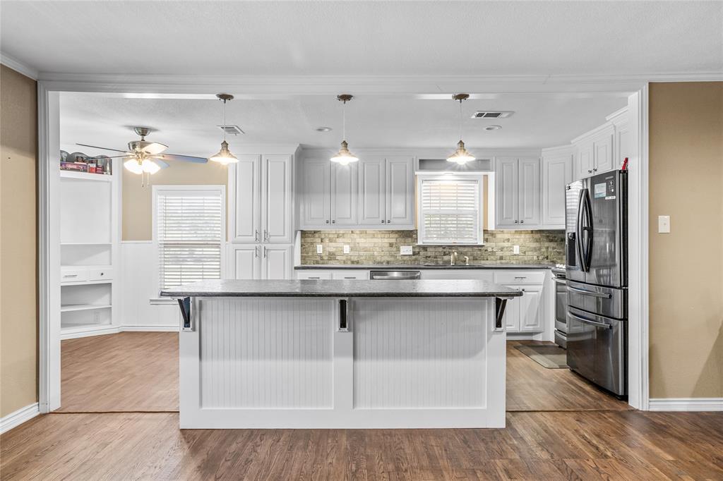 1825 North Highland Avenue Sherman, TX 75092 - Photo 12 of 38 a kitchen with stainless steel appliances granite countertop a sink a stove and a refrigerator