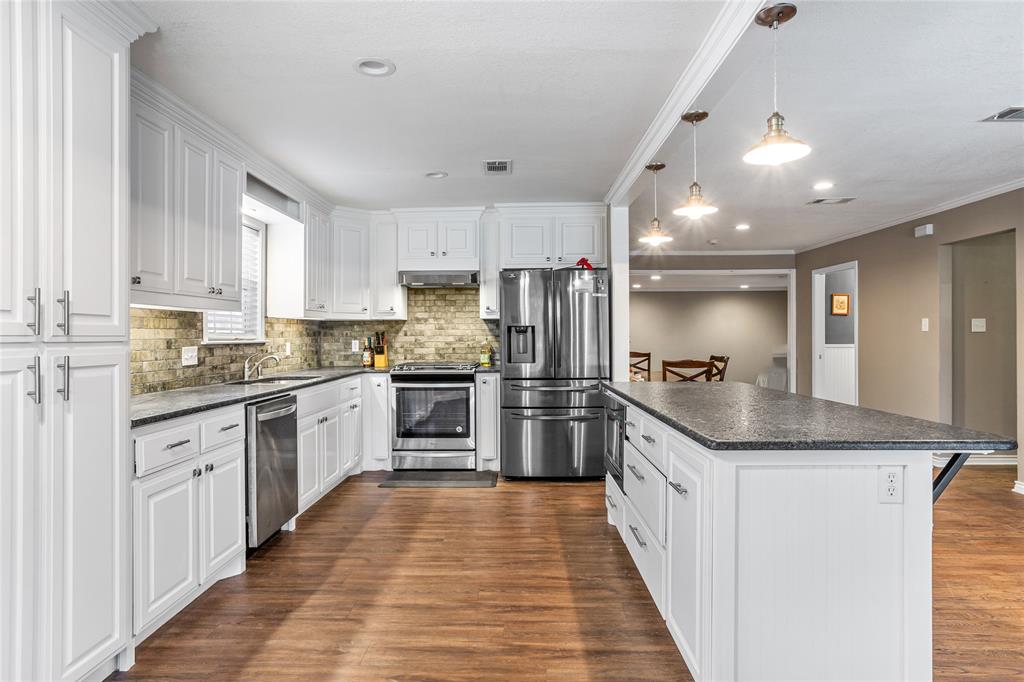 1825 North Highland Avenue Sherman, TX 75092 - Photo 14 of 38 a kitchen with stainless steel appliances granite countertop a sink and refrigerator
